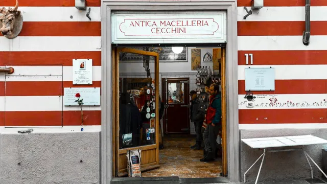 Striped storefront with an open door, people inside, red and white stripes on walls.
