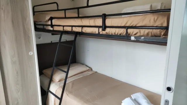 Bunk beds with bedding and towels.