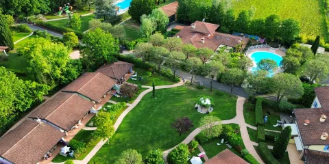 Aerial view of lush green garden with pools and pathways.