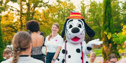 Spotty entertaining children at outdoor gathering.
