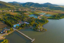 Aerial view of a scenic lakeside resort with mountains in the background.