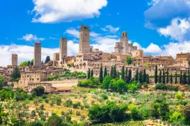 Medieval town with stone towers under a bright blue sky.