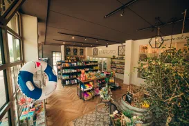 Store interior with shelves of colorful products and a hanging lifebuoy.