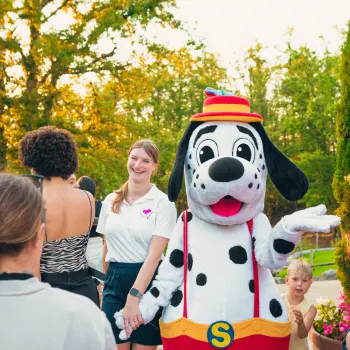 Spotty entertaining children at outdoor gathering.