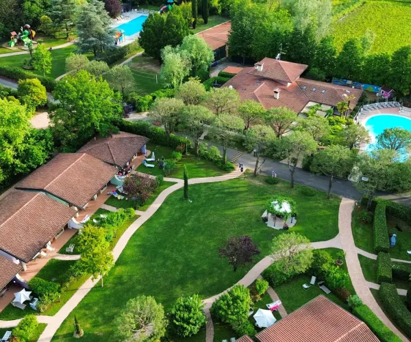Aerial view of lush green garden with pools and pathways.