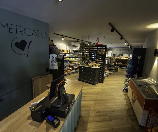 Small grocery store interior with shelves and checkout counter.